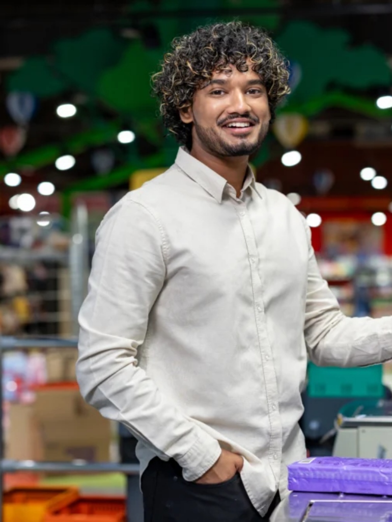 smiling-man-using-smartphone-at-a-self-checkout-in-2026-03-05-11-24-34-utc